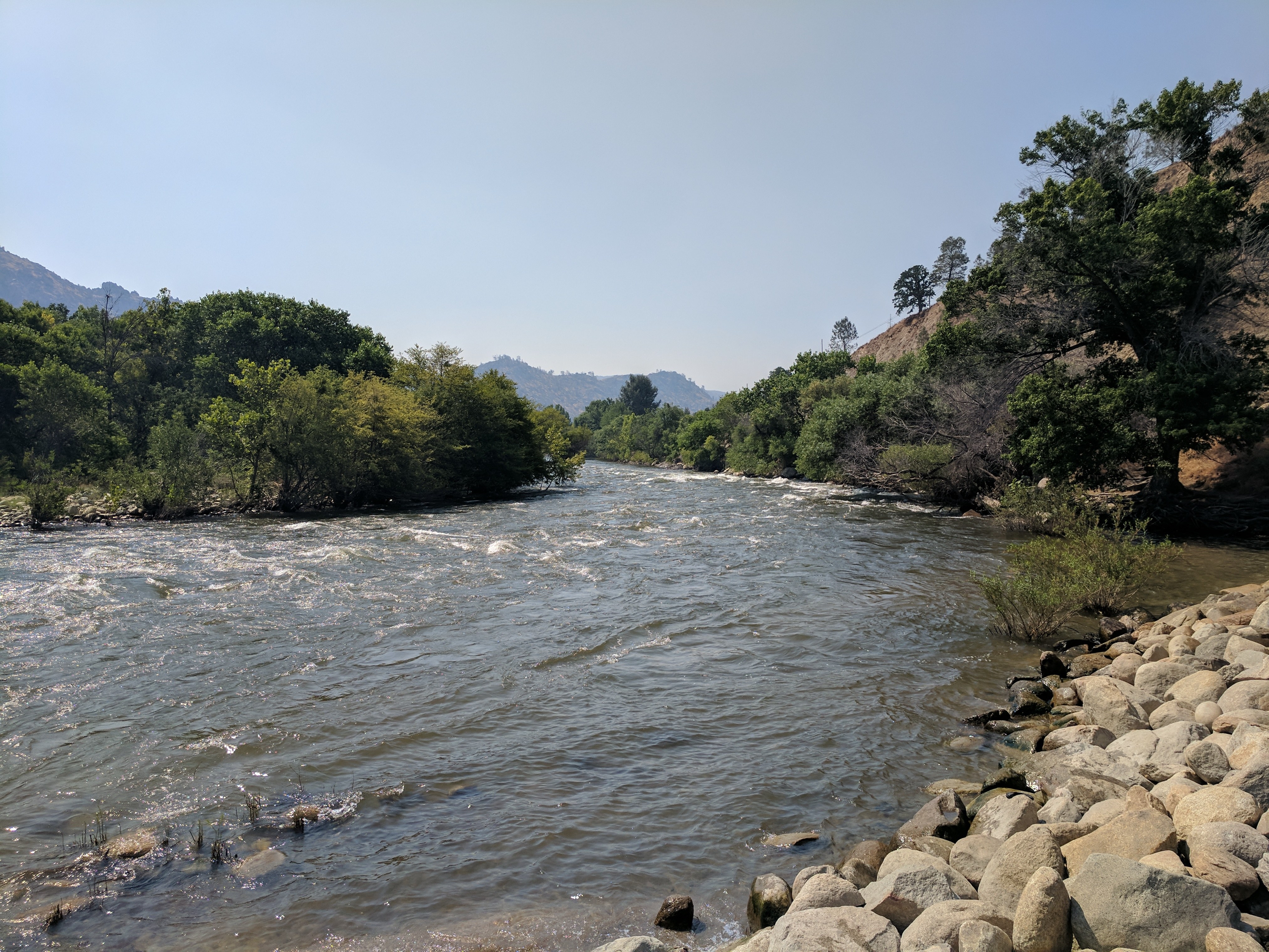 Kern River with rushing water and rocky banks surrounded by mountains